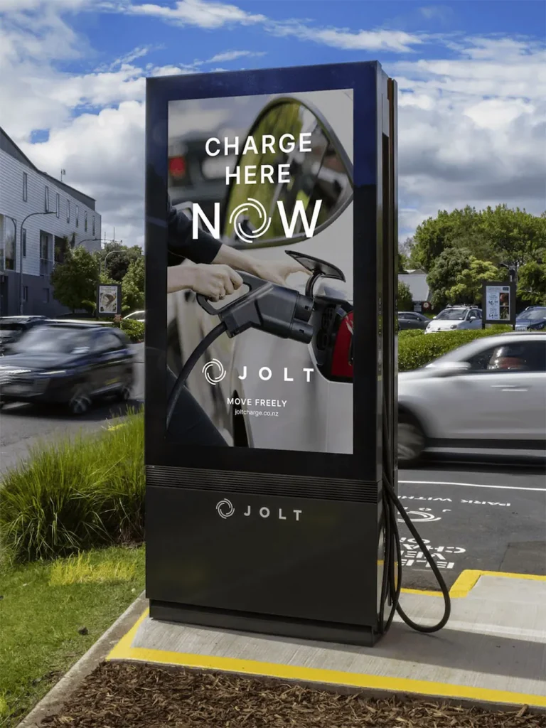 A charging station with a digital display and an electrical cable on the side