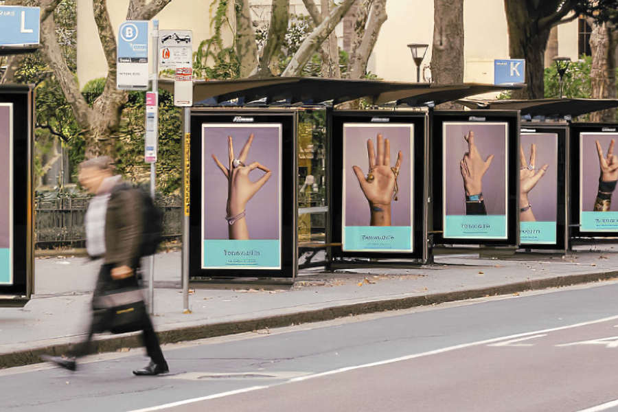 Five displays with hands - all with jewelry on in a row of bus stations