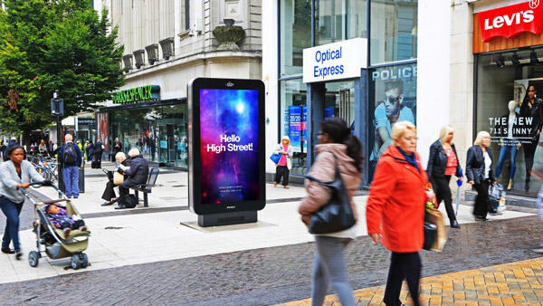Pedestrian street with a freestanding digital ad kiosk