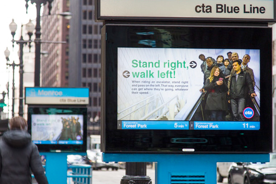 Two large digital displays in a city setting