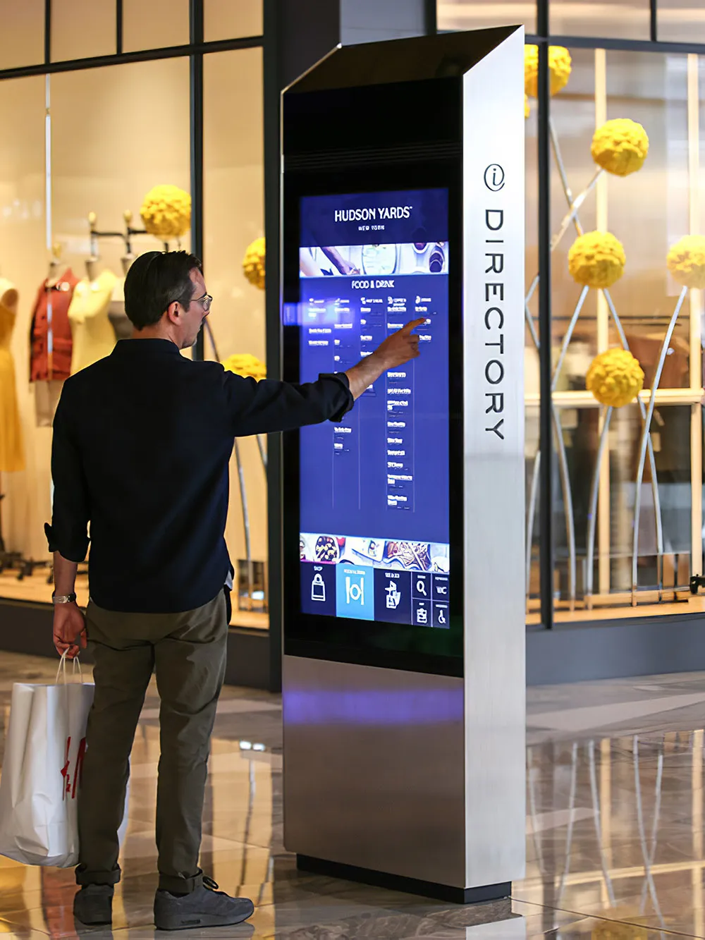 A shopper interacts with a BoldVu® kiosk at Hudson Yards in New York